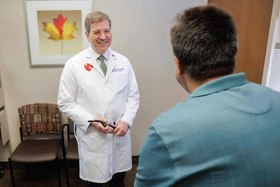 A patient being examined by their infectious diseases physician.