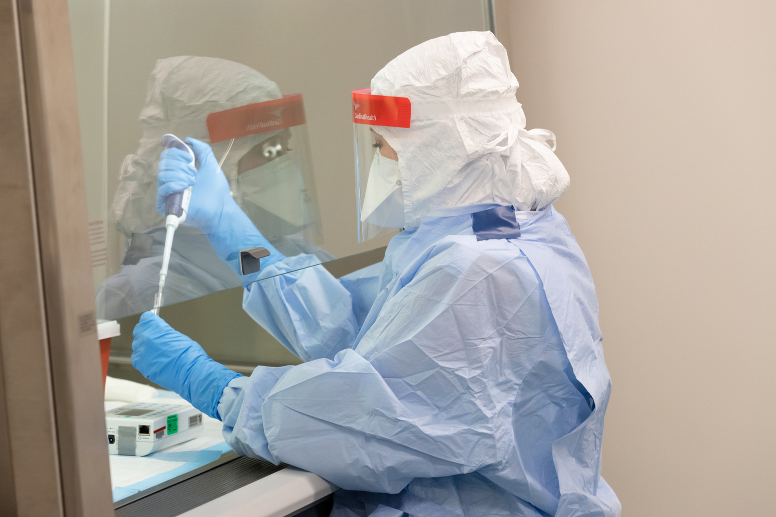 An infectious diseases researcher testing a sample in a lab.