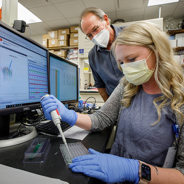 Dr. Thiele and resident conducting experiment