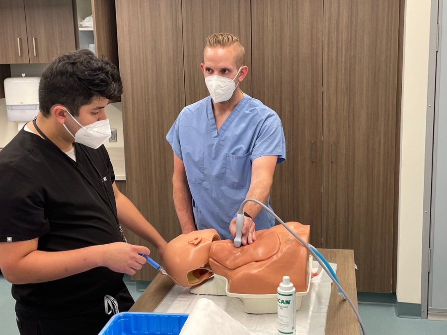 Dr. Hettenbaugh teaching Dr. Magliulo