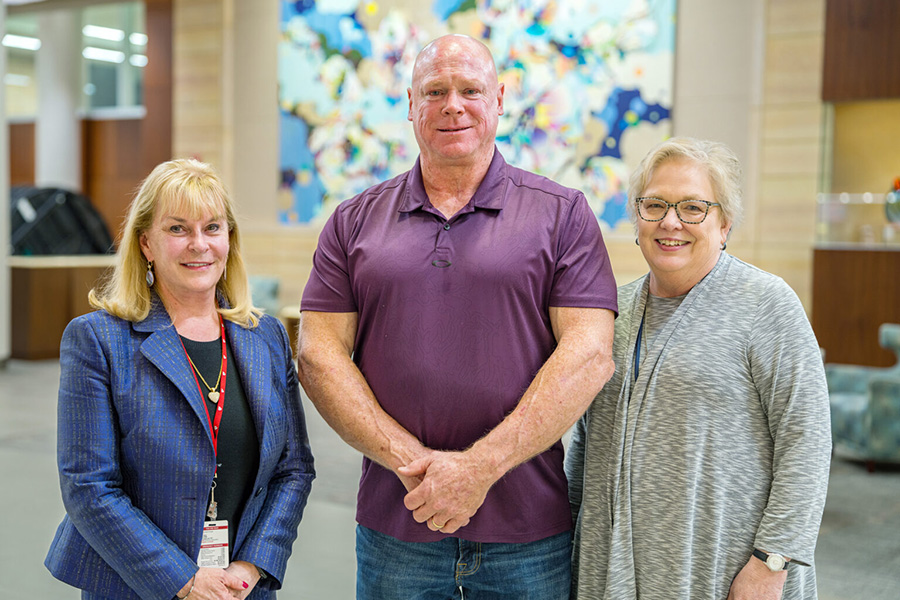 Julie Vose, MD, transplant patient Kurt Holmstrom and Beth Reed, MD, at an anniversary celebration for the program.
