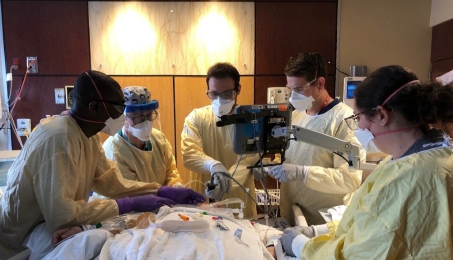 Fellows working together on a procedure