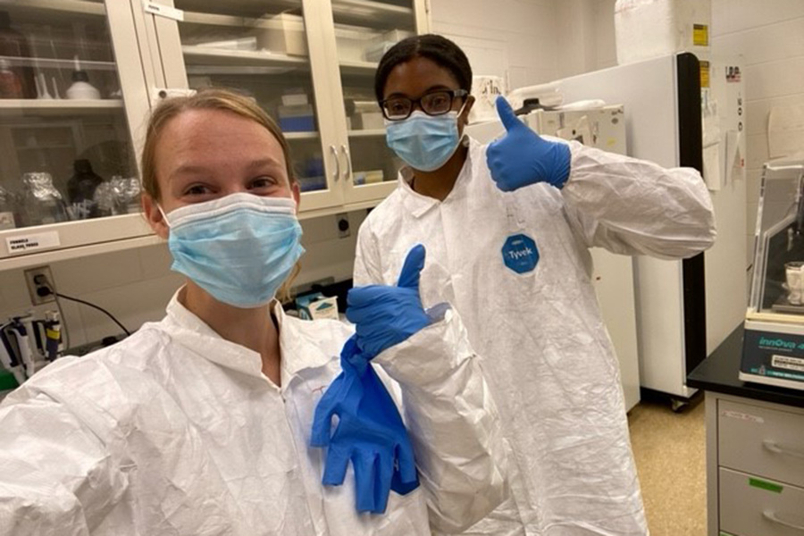 Students in lab gear in lab