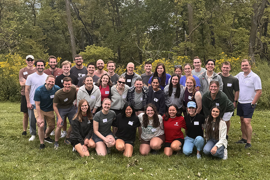 The UNMC internal medicine residents pose outdoors in casual clothing during a retreat