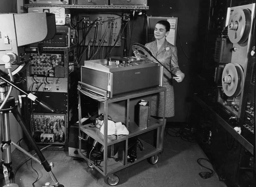 Biomedical Communications staff member Reba Benschoter examines film reel in an audio visual equipment room in 1967.