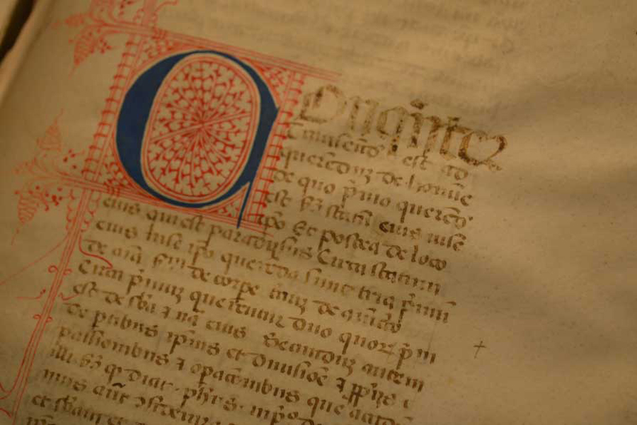14th century Latin text with ornate lettering and decoration