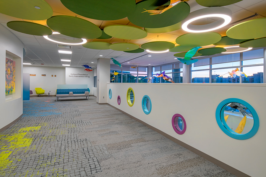 MMI interior 2nd floor, vibrant colored circles in greens, blue and purple on the floor and ceiling, grey and green floor.