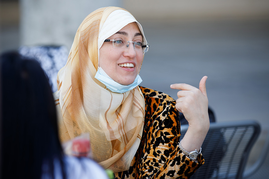 International student sharing lunch with peers on campus, credit Kent Sievers – UNMC.