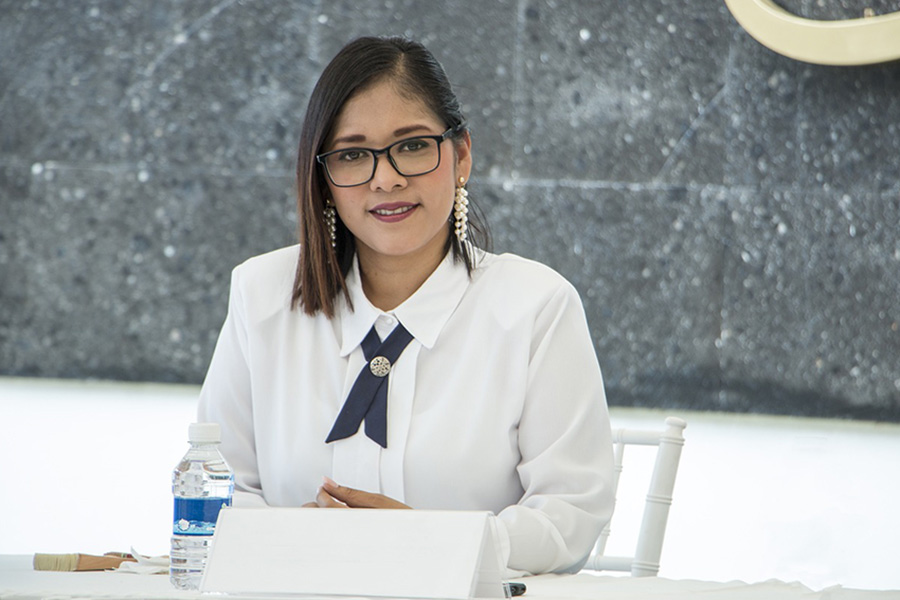 Woman sitting at a table.
