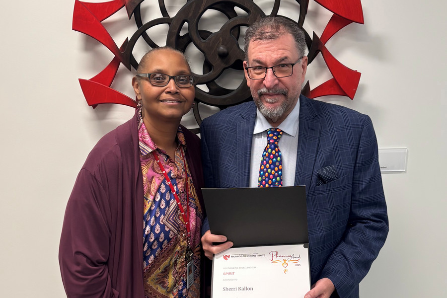 Sherri Kallon accepts award from Dr. Mirnics