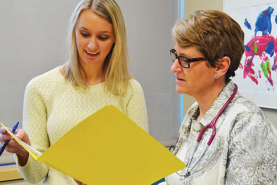 A faculty member works with an intern.