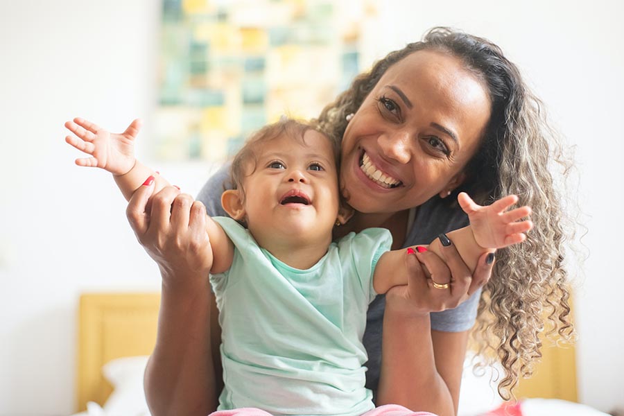 Caregiver and child smiling, Kampus Production - Pexels.