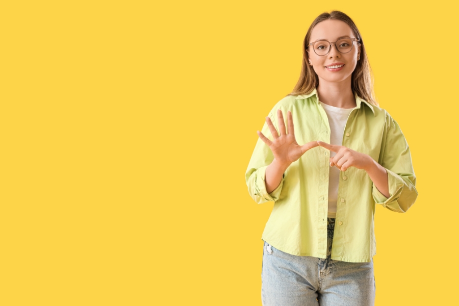 A young adult communicating with sign language.
