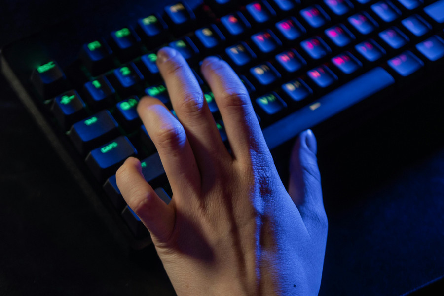 Hand typing on a keyboard.