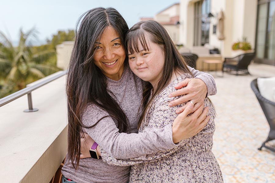 Mother hugging adult daughter who has Down syndrome, credit RodnaeProductions - Pexels.