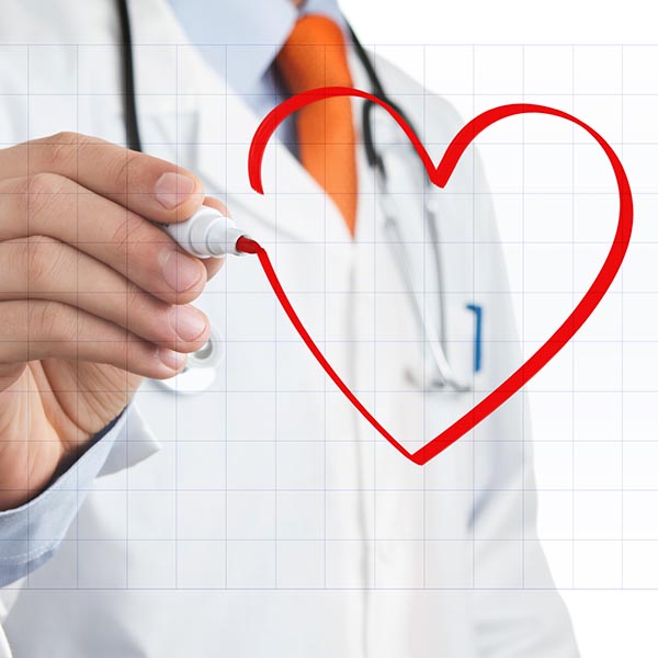 A doctor drawing a red heart on a board