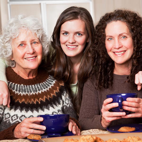 Three generations of women drinking coffee