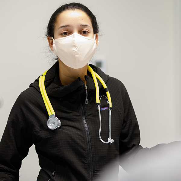 Resident physician wearing stethoscope around neck and facemask, credit Kent Sievers 2021 – UNMC.