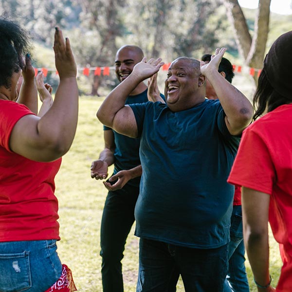 Adults high-five outside, Rodnae Productions - Pexels.