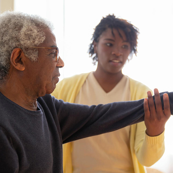 Health care provider working with an adult patient on physical therapy, credit Kampus Production – Pexels.