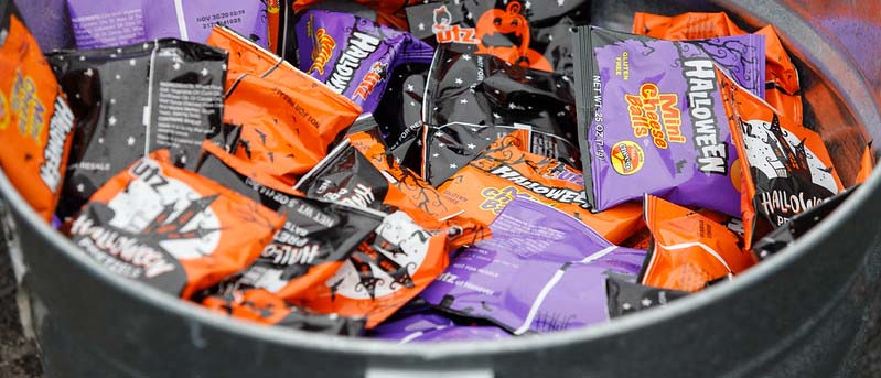 Individually packaged Halloween snacks in a bowl.