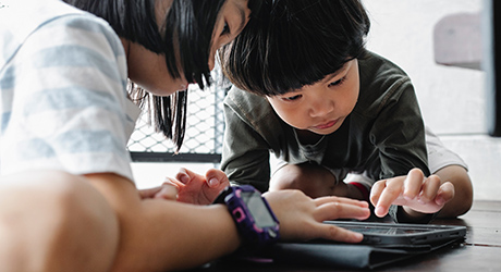 Two children interacting with a tablet; credit Alex Green from Pexels.