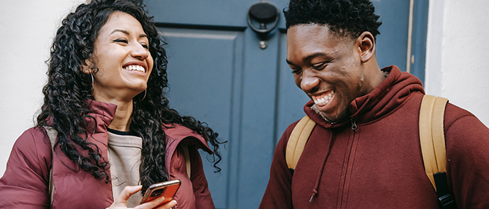 Two students laughing, by Keira Burton - Pexels.