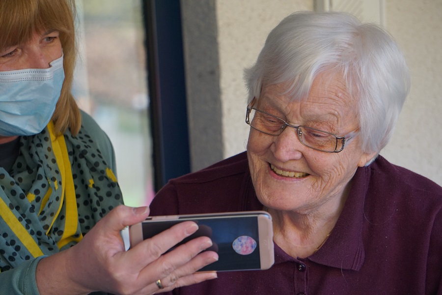 Elderly woman reading on phone