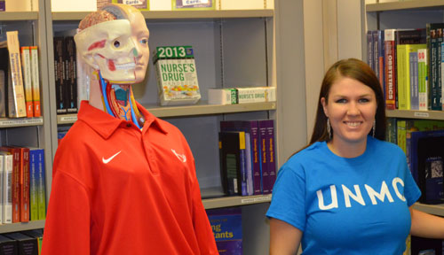 Bookstore employee Hannah Stanzel and friend invite the UNMC community to check out the store's inventory reduction sale.