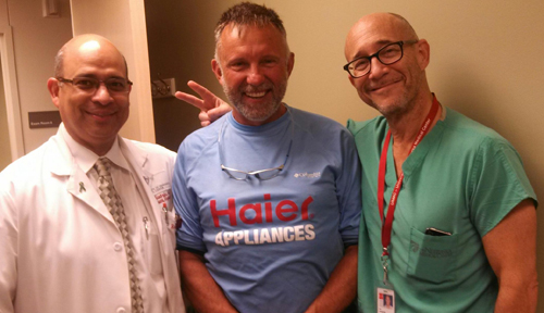 Rubin Quiros, M.D., (left) and Alan Langnas, D.O. (right), met with Don Erickson.