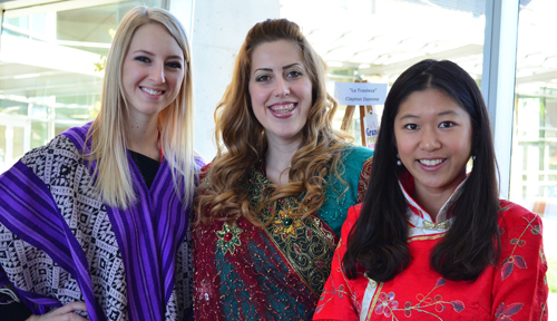 From left, Jessica Wooden, Ariel Burns and Bei Jiang respectively don Peruvian, Indian and Chinese dress during International Week.