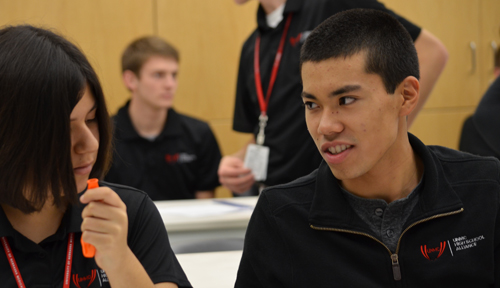 Noah Yoshida, right, speaks with another UNMC High School Alliance student, Alexis Reza of Bellevue East.