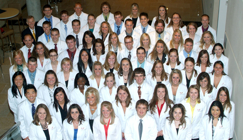 The College of Pharmacy's 2013 graduating class at their white coat ceremony in 2009. Dean Courtney Fletcher, Pharm.D., is at top left.
