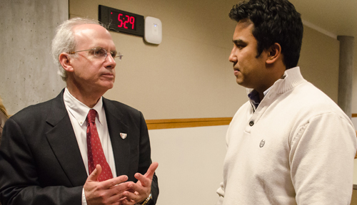 Jeffrey P. Gold, M.D., left, speaks with Jeremy Hosein, Student Senate past president, at a meeting of the Student Senate Wednesday night.