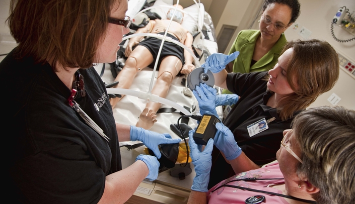 Health professionals train in the Biocontainment Unit with a simulated patient in an isopod.