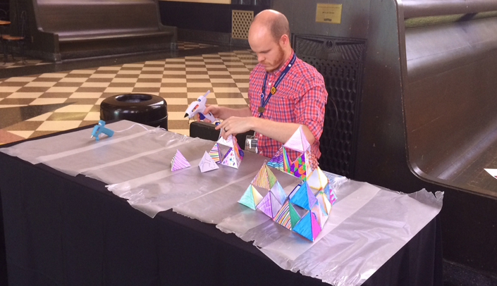 A Durham museum staff member sets up an activity for UNMC visitors at Participant's Night.