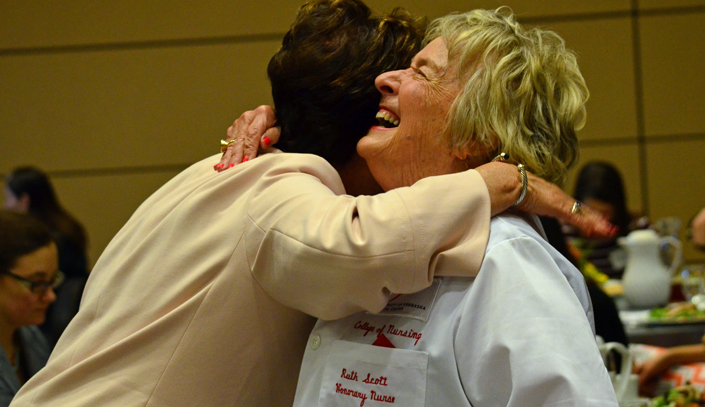 Ruth Scott, longtime UNMC supporter and honorary nurse (note her official UNMC white coat), received a hug from Juliann Sebastian, Ph.D., dean of the College of Nursing, at last week’s UNMC College of Nursing Omaha Scholarship Lunch.