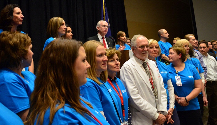 UNMC Chancellor Jeffrey P. Gold, M.D., congratulates staff members of the Nebraska Biocontainment Unit Friday.
