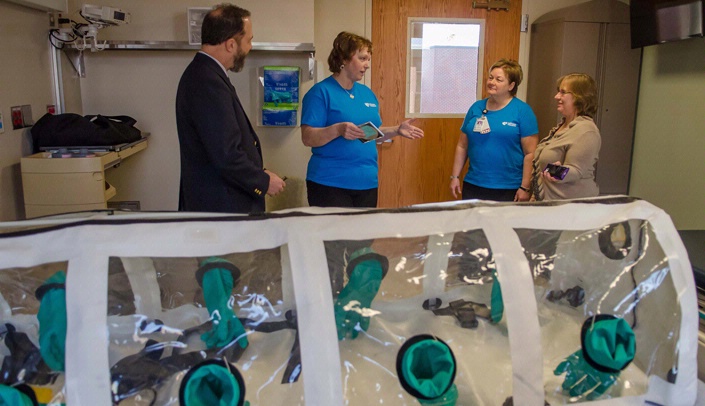 Rick Sacra, M.D., left, and his wife Debbie, far right, visited the Nebraska Biocontainment Unit Friday, one day after state lawmakers approved a resolution recommending that an infectious disease training center be established in Nebraska