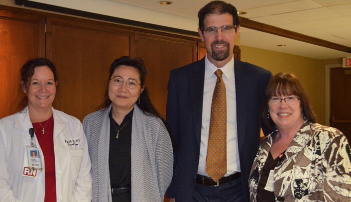 After 14 years at UNMC, Aaron Sasson, M.D. (second from right), will be leaving at the end of this month to become chief of surgical oncology at Stony Brook University in Stony Brook, N.Y. A farewell tea was held for Dr. Sasson on Wednesday. He is joined here by his team (left-right) Rachel Burg, case management nurse, Quan Ly, M.D., associate professor, surgical oncology, and Melissa Campbell, office associate.