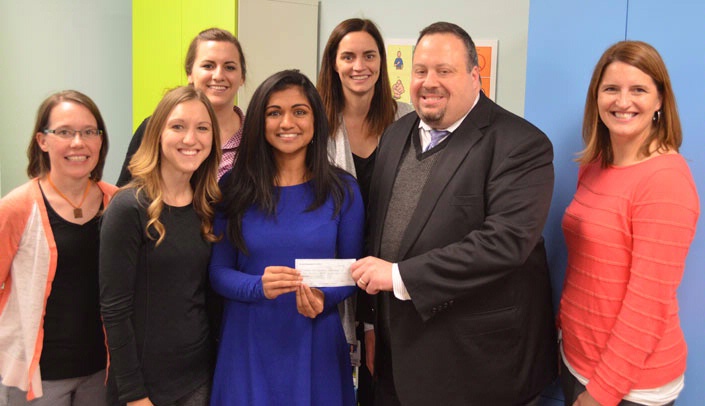 UNMC medical students from Phi Rho Sigma Medical Society presented a $2,000 check to representatives of the Munroe-Meyer Institute and the Scottish Rite Foundation Thursday. From left, speech therapist Korey Stading, medical student Lindsey Kendrick, speech therapist Leslie Van Winkle, medical student Sasha Kapil, speech therapist Beth Hughes,  Micah Evans of the Scottish Rite Foundation of Omaha, and Amy Nordness, Ph.D., director of the Munroe-Meyer Institute's RiteCare Speech & Language Clinic, gathered for the presentation. Kendrick and Kapil, philanthropy co-chairs of the UNMC chapter of Phi Rho Sigma, are presenting a check for $2,000 to Evans to support services at the clinic. The funds, raised at a Sept. 27 golf scramble held by Phi Ro Sigma, will provide 20 sessions of speech and language therapy to clients of the clinic.