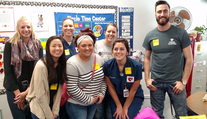 College of Allied Health Profession radiation science and technology students at an elementary school, delivering coats, gloves and hats.
