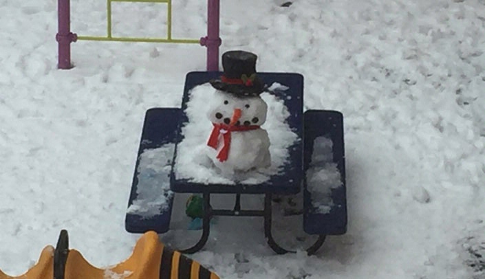 Children and members of the staff of UNMC's Childcare Development Center built a snowman to ease the after-holiday blues earlier this week. The center provides childcare for the children of UNMC students, faculty and staff.