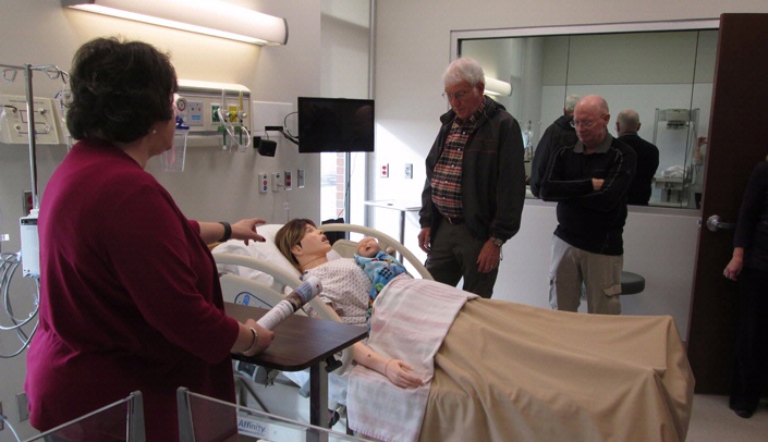 Denise Waibel-Rycek, instructor for the UNMC College of Nursing Kearney Division, describes the functions of the birthing manikin in the Simulation Suite at the new Health Science Education Complex at the University of Nebraska at Kearney. The building, which opened in August, houses more than a dozen UNMC nursing and allied health programs. Ryan Splittgerber, Ph.D., assistant professor with the UNMC College of Allied Health Professions - Kearney Campus, also talked about new technology in the building.