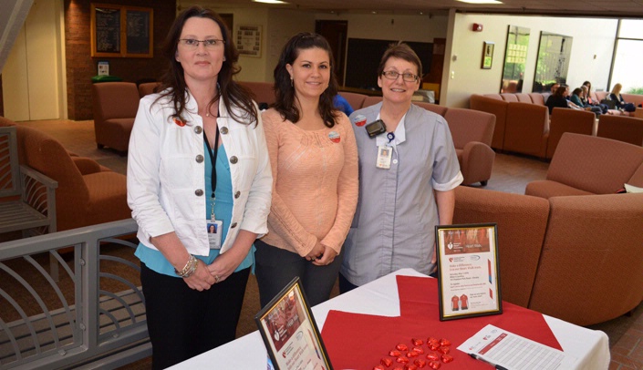 Paula Nenneman, general manager of environmental services, Cherylyn Gifford, patient services manager in food nutrition, and Tami Howell, EVS associate, prepare to sign up Heart Walk participants Tuesday.