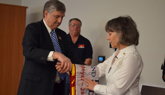 Jim Meier presents Genia Meyer with the Honor and Remember Flag.