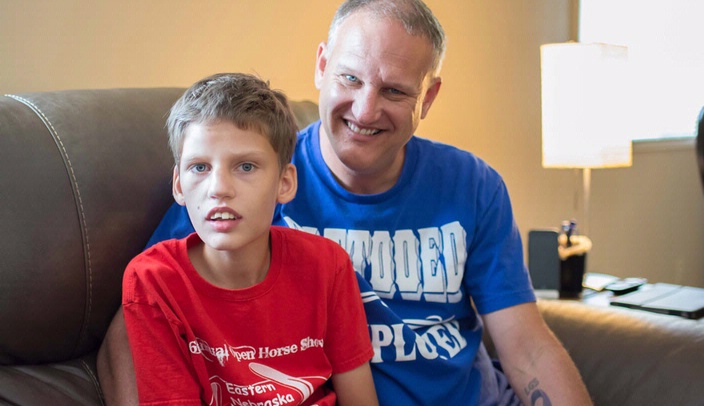 Broc Bartenhagen (left), a 14-year-old from Gretna, Neb., with drug-resistant epilepsy, is a potential candidate for the cannabidiol study being conducted at UNMC. He's seen here with his father, Mike Bartenhagen.