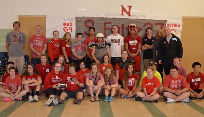 Four members of the University of Nebraska Cornhusker football team came to visit Camp Munroe this week. Posing for a photo with the campers, in front of a banner the campers made to honor Husker punter Sam Foltz, who died in a car crash on July 24, are (all in back row) Grant Jordan, second from left, Spencer Jordan (in white), Jordan Nelson (second from right) and Harrison Jordan (far right).