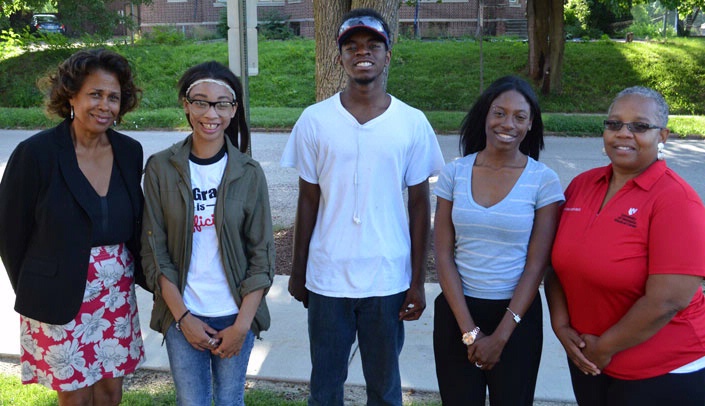 Aileen Warren, associate vice chancellor and director of human resources, left, and program coordinator Evelyn Grixby, right, pose in 2016 with the first co-hort of Step-Up interns -- from left, Kayontae Bell, Michael Hughes and DeVenae Henderson. The job-training program will return to campus this month.