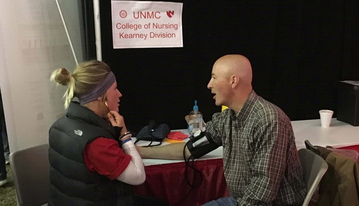 Nursing student Kaitlyn Augustyn takes Nebraska Gov. Pete Ricketts' blood pressure.